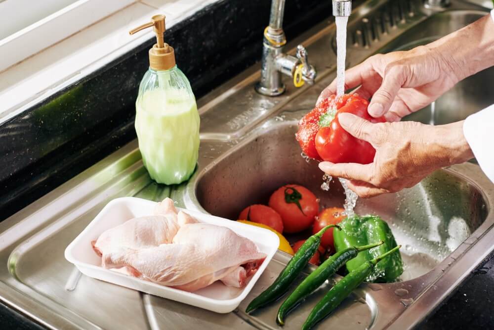washing vegetable at the sink