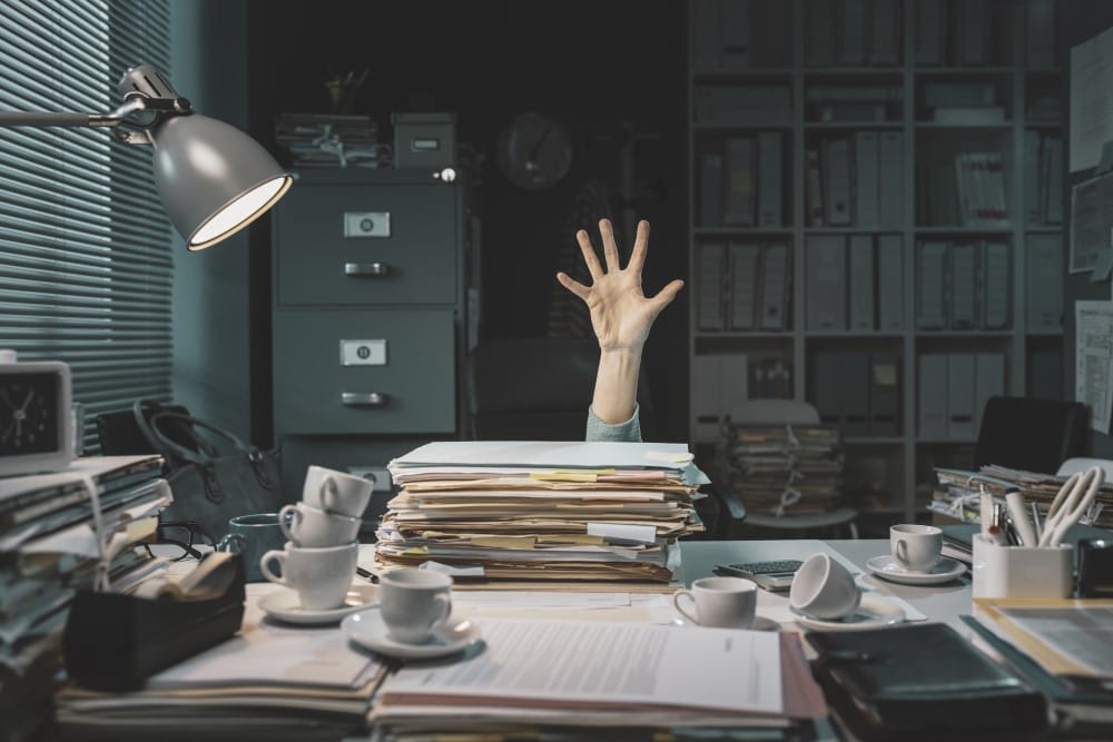 employee overwhelmed with paperwork