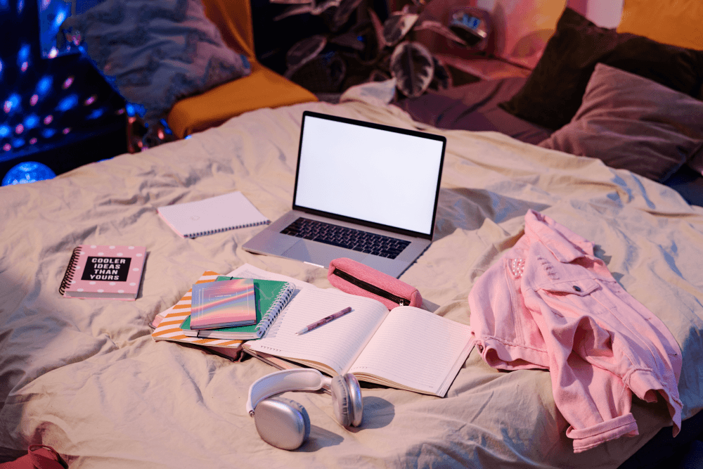 laptop and office equipment on bed