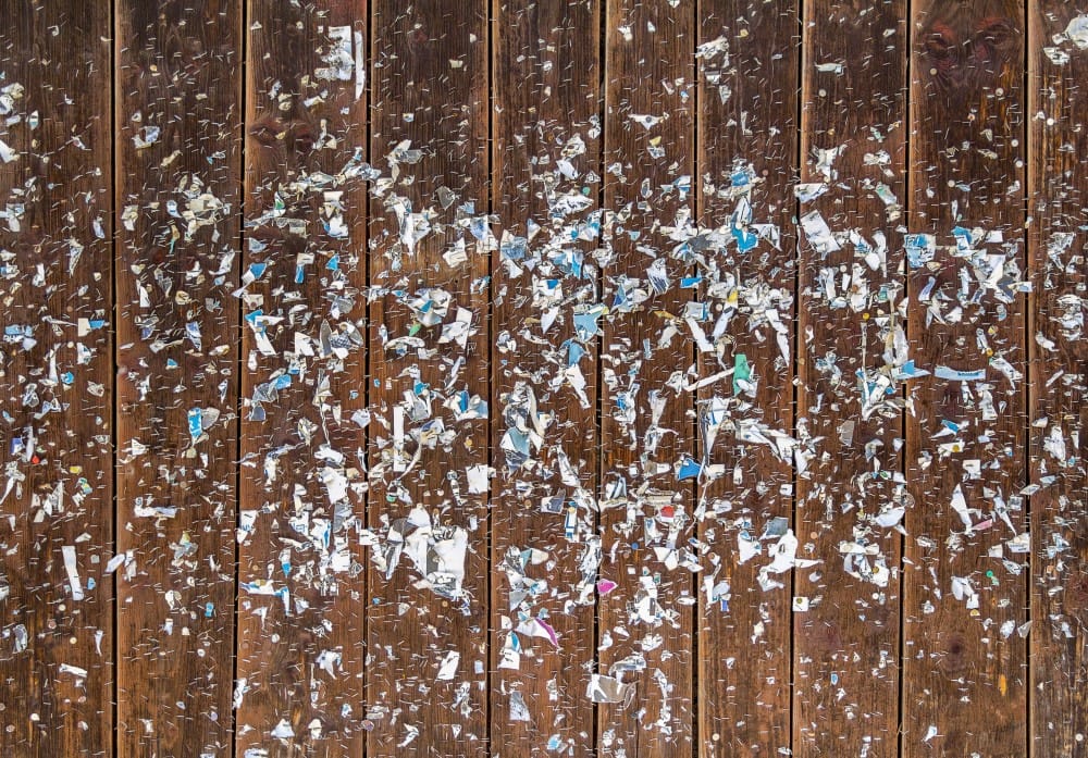 dirty sticker residue on wooden surface