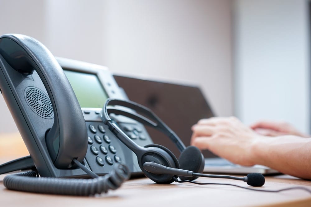 telephone and headset in call center agent office