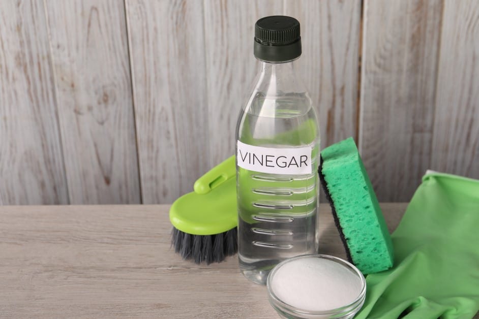 natural cleaning products vinegar, baking soda, glove, and sponge