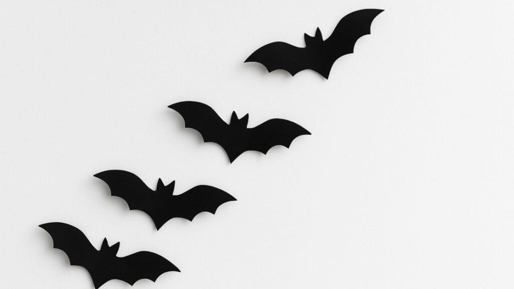 Paper bats arranged on a white wall