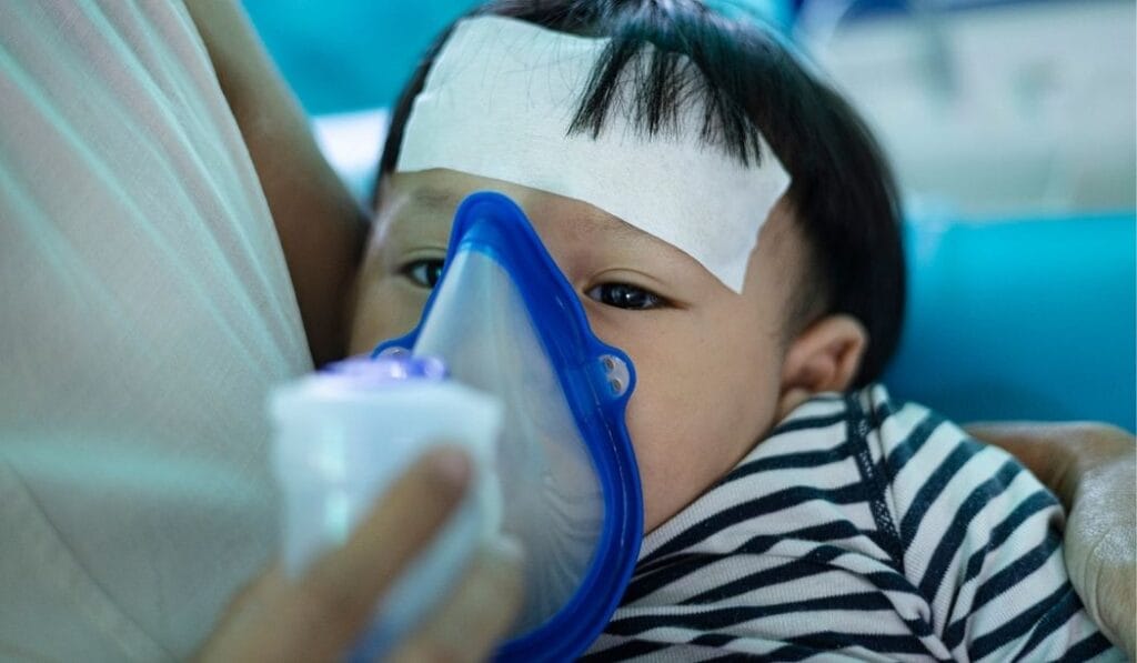 Child using inhaler due to asthma triggered by household mold