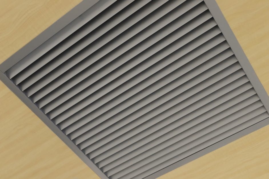 Close-up of a ceiling ventilation duct where hidden mold can develop