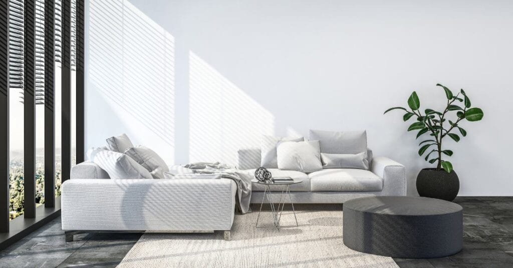 Bright condo living room uses light walls and neutral furniture to contrast dark floors and appear bigger.