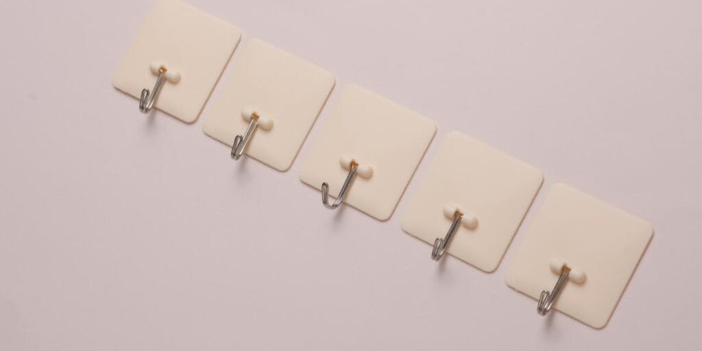 Durable adhesive hooks used for hanging wall decor safely without using nails.