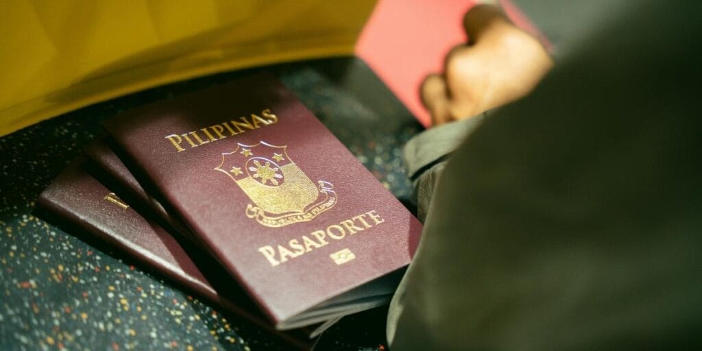 A stack of Philippine passports showing the official gold seal.