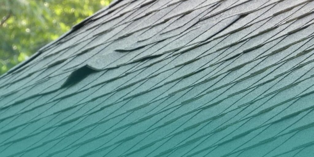 Loose roof shingles that may allow rainwater to leak into a home during the rainy season.