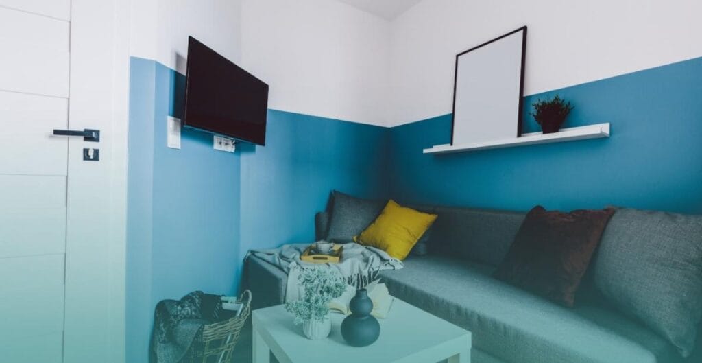 small living room where all furniture is pushed directly against the walls,
