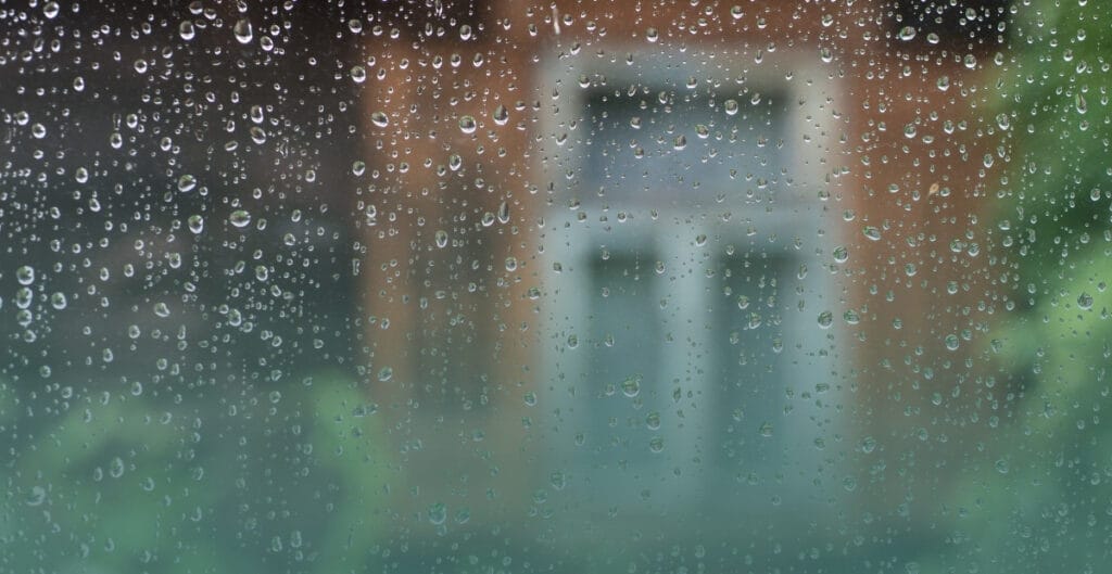 Raindrops on a window overlooking a rainy day during the Philippine monsoon